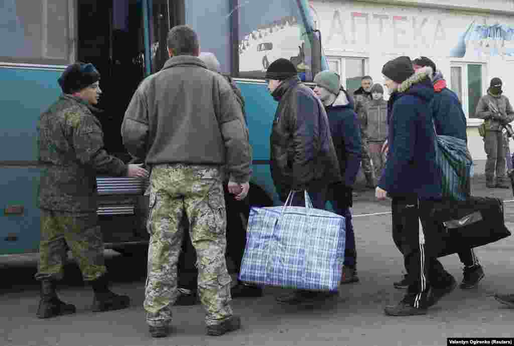 UKRAINE -- Prisoners of war (POWs) from the separatist self-proclaimed Luhansk People's Republic (LNR) board a bus during the exchange of captives near the city of Bakhmut in Donetsk region, December 27, 2017