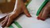 Georgia -- An election official counts voting papers ahead of the parliamentary elections at a polling station in Tbilisi, October 7, 2016