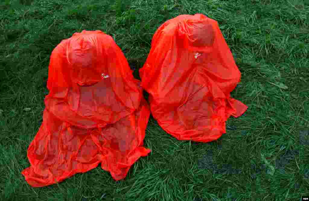 Catholic pilgrims wearing raincoats pray before the opening ceremony of World Youth Day in Krakow, Poland on July 26. (Reuters/David W Cerny)