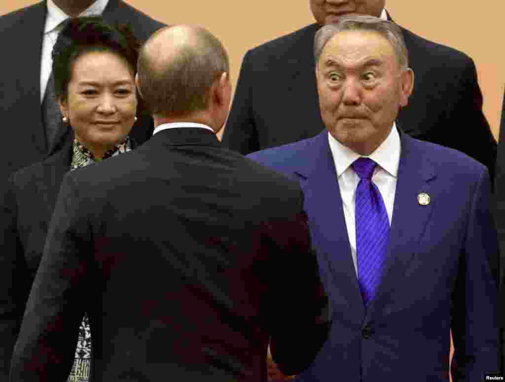 Kazakh President Nursultan Nazarbaev (right) reacts during a handshake with Russian President Vladimir Putin during a group photo for the fourth Conference on Interaction and Confidence Building Measures in Asia summit in Shanghai on May 20. (Reuters/Ng Han Guan/Pool)