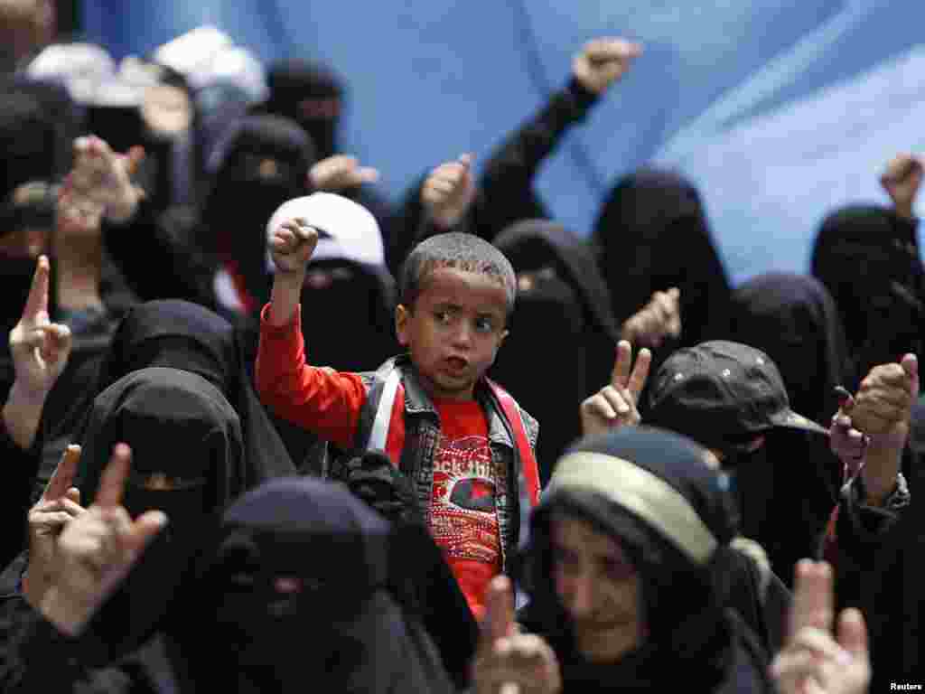 A boy and female antigovernment protesters shout slogans during a demonstration demanding the resignation of Yemen's President Ali Abdullah Saleh outside Sanaa University on March 29. Photo by Ammar Awad for Reuters
