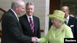 Queen Elizabeth greets Northern Ireland's deputy first minister, Martin McGuinness, in Belfast on June 27.
