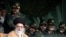 In front of Iranian Revolutionary Guards commanders, supreme leader Ayatollah Ali Khamenei, bottom left, attends a gathering of Basij paramilitary forces, in Tehran, Iran, Monday, Nov. 26, 2007.