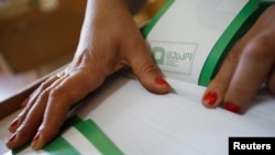 Georgia -- An election official counts voting papers ahead of the parliamentary elections at a polling station in Tbilisi, October 7, 2016