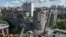 Firefighters work at a site of the apartment building damaged during a Russian missile and drone strike in Kyiv on May 14, 2026.