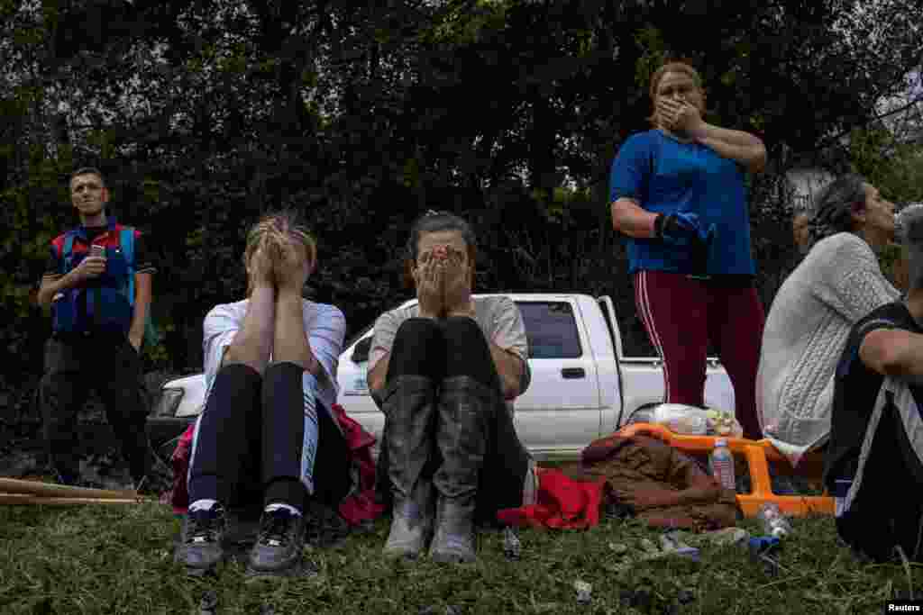 Locals react after floods and landslides hit the village of Trusina in Bosnia-Herzegovina.&nbsp;