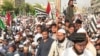 Supporters of the Pakistan Democratic Movement protest in the port city of Karachi against price hikes of petroleum, electricity, and daily commodities on October 23.