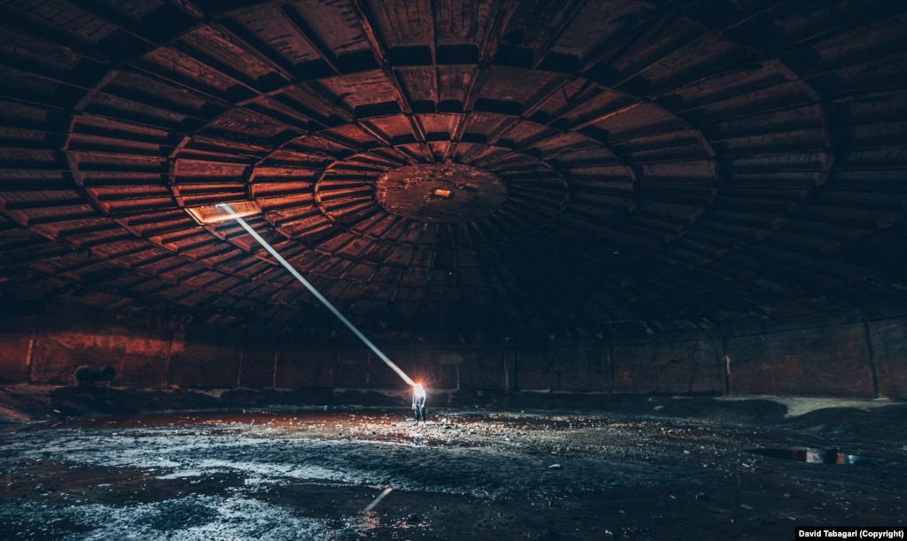 A shaft of sunlight cuts through the space of an empty Soviet-era water reservoir on the outskirts of Tbilisi.