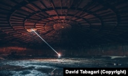 A shaft of sunlight cuts through the space of an empty Soviet-era water reservoir on the outskirts of Tbilisi.