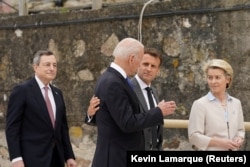 French President Emmanuel Macron (center right), U.S. President Joe Biden (center left), European Commission President Ursula von der Leyen (right), and Italian Prime Minister Mario Draghi talk at the G7 summit in July where they announced the Build Back Better for the World (B3W) program meant to compete with China’s BRI.