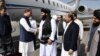 Pakistani Foreign Minister Shah Mahmood Qureshi (left) is welcomed upon arriving in Kabul on October 21. 