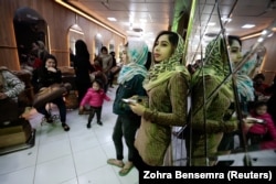 Customers wait for their turn at a beauty parlor in Kabul.