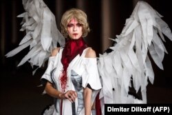 A woman models a dress during a funeral fashion show of "mourning dresses."