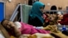 Farzana, 30, holds her 1-year-old son, Omar, at the malnutrition ward for infants at Indira Gandhi Children's Hospital in Kabul on October 23.