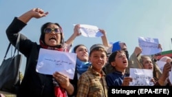 Afghan women shout slogans during a protest to demand the Taliban-led government allow the reopening of girls' schools and to provide ample employment opportunities, in Kabul on October 21.