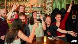 Ljudi slave u jednom od pubova u Melbournu, 22. listopada 2021.