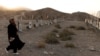 A woman walks through a Hazara cemetery on the outskirts of Kabul on October 21.