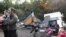A Romany family from Romania stand near their tent shelter after police removed their caravan overnight in an illegal camp in Lesquin, near Lille. France insists it has acted legally.