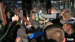 After a peaceful demonstration earlier in the day in the Biryulevo neighborhood of Moscow, gangs of mostly young men broke shop windows and inflicted other damage on the area, many of them chanting nationalistic slogans as the unrest mounted.