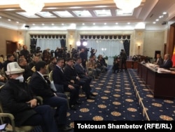 Kyrgyz lawmakers gather outside of Bishkek on October 10.