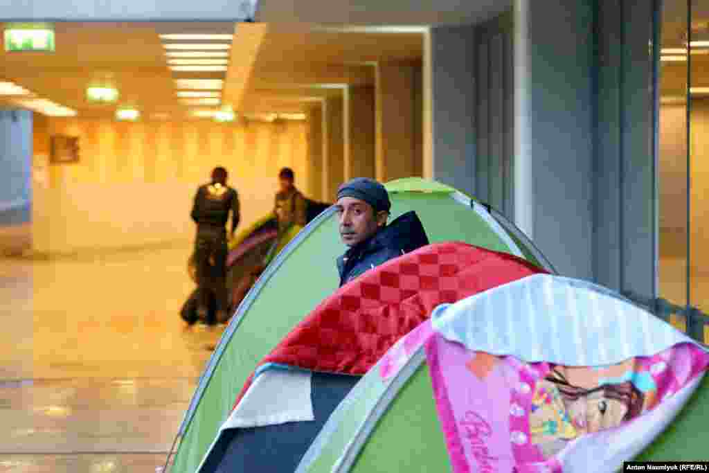 Migrants are mainly arriving in Budapest via neighboring Serbia, with whom Hungary has a simplified border-crossing regime. Many of them hope to travel onward from the Hungarian capital to Austria, Germany, and other EU countries. The tents in the picture have been erected in a designated transit area for migrants in a pedestrian underpass near Keleti railway station.