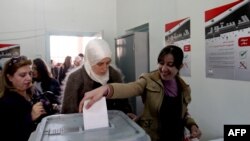 Syrian women in Damascus cast their ballots in a referendum on a new constitution on February 26.