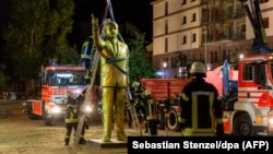 German firemen remove a 4-meter-tall golden statue of Turkish President Recep Tayyip Erdogan in the western German town of Wiesbaden on August 28. 