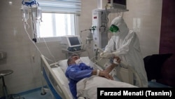 An Iranian medic treats an infected patient sick with the COVID-19 virus at a hospital in Kermansha on March 3.