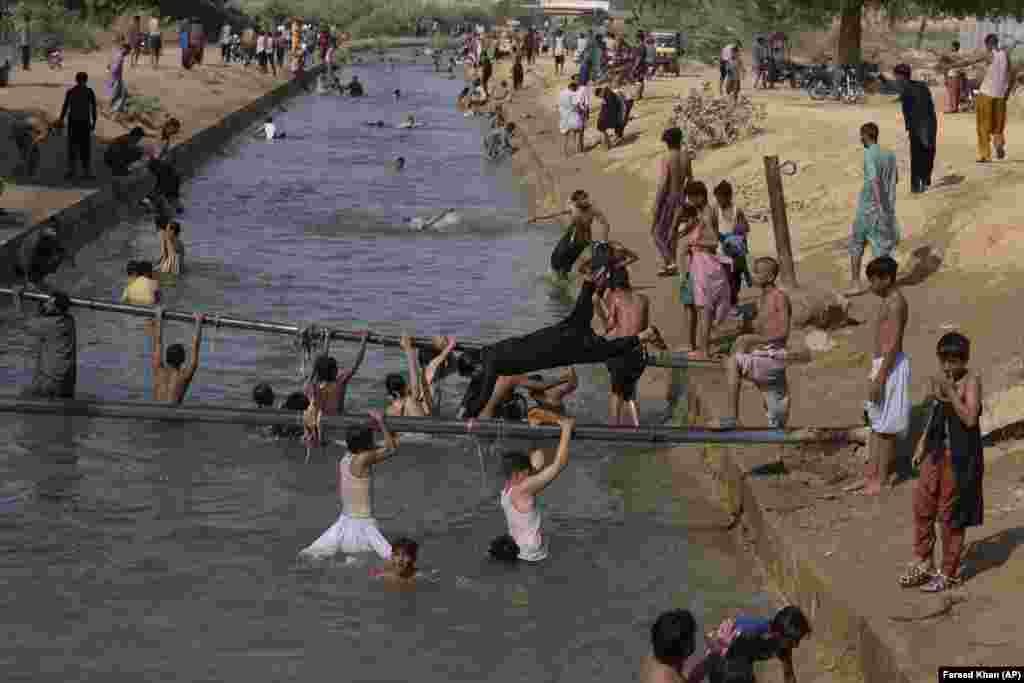 People swim in a canal to cool themselves as temperatures reached 37 Celsius (98.6 F) on the outskirts of Karachi, Pakistan, on April 6.