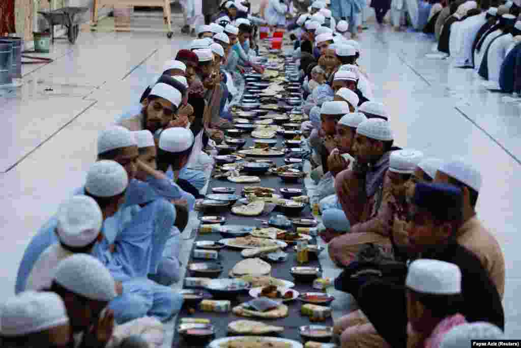 People pray before breaking their fast during the Muslim holy month of Ramadan at a mosque in Peshawar, Pakistan.