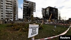 A mine-warning sign is seen in front of buildings that were destroyed by Russian shelling in Borodyanka, outside Kyiv, on April 7.