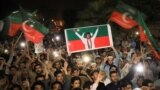 Supporters of Imran Khan's Tehrik-e Insaf (PTI) party wave flags and chant in support of the former prime minister at a rally in Peshawar on April 10.