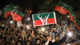 Supporters of Imran Khan's Tehrik-e Insaf (PTI) party wave flags and chant in support of the former prime minister at a rally in Peshawar on April 10.