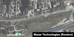 A satellite image shows armored vehicles and trucks of a Russian military convoy moving south through the town of Velykyi Burluk in eastern Ukraine on April 8. Maxar Technologies said the convoy consisted of hundreds of vehicles and extended for at least 13 kilometers.