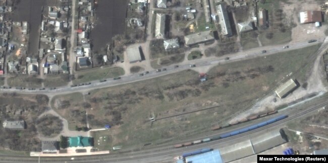 A satellite image shows armored vehicles and trucks of a Russian military convoy moving south through the town of Velykyi Burluk in eastern Ukraine on April 8. Maxar Technologies said the convoy consisted of hundreds of vehicles and extended for at least 13 kilometers.