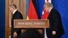 Germany's Chancellor Olaf Scholz (left) and Britain's Prime Minister Boris Johnson leave after holding a joint press conference at 10 Downing Street in London on April 8.