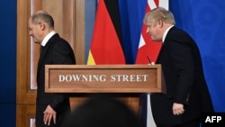 Germany's Chancellor Olaf Scholz (left) and Britain's Prime Minister Boris Johnson leave after holding a joint press conference at 10 Downing Street in London on April 8.