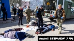 Rescue personnel tend to victims of a Russian attack on the railway station in the eastern city of Kramatorsk on April 8.