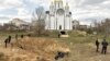 Bodies of civilians exhumed from a mass grave lay in plastic bags in Bucha, near Kyiv, which was recaptured by the Ukrainian Army from Russian forces, who are accused of committing war crimes.