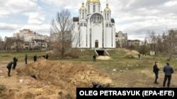 Bodies of civilians exhumed from a mass grave lay in plastic bags in Bucha, near Kyiv, which was recaptured by the Ukrainian Army from Russian forces, who are accused of committing war crimes.