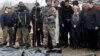 European Commission President Ursula von der Leyen, foreign policy chief Josep Borrell (second from right), and Slovak Prime Minister Eduard Heger (fourth from right) stand next to bodies that were exhumed from a mass grave as they visited the town of Bucha on April 8.