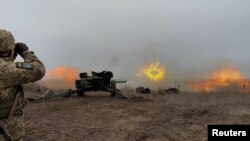 Ukrainian armed forces hold artillery drills at an unknown location in eastern Ukraine in December 2021.