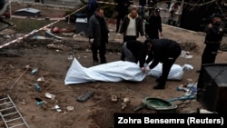 The bodies of civilians who local officials say were killed by Russian soldiers are seen after their exhumation from a mass grave in Buzova on April 10.