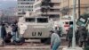  U.N. peacekeepers and Sarajevo citizens take cover from gunfire on the city's infamous "Sniper Alley"