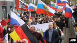 People take part in a pro-Russia rally in Frankfurt on April 10.