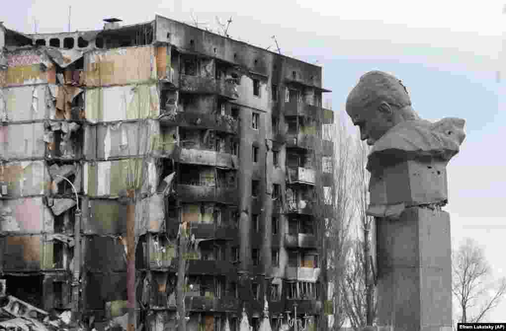 A monument to Ukrainian poet Taras Shevchenko, a towering figure in Ukrainian culture, is scarred by shrapnel and bullet holes in the central square in Borodyanka after Russian shelling.