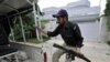 A Pakistani policeman in front of the locked residence of Faisal Shahzad near Peshawar