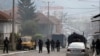 Kosovo Tensions -- Kosovo police officers guard a street in the northern Serb-dominated part of ethnically divided town of Mitrovica, Kosovo, Wednesday, Oct. 13, 2021. Kosovo police have clashed with ethnic Serbs in the north during an operation against s