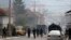 Kosovo Tensions -- Kosovo police officers guard a street in the northern Serb-dominated part of ethnically divided town of Mitrovica, Kosovo, Wednesday, Oct. 13, 2021. Kosovo police have clashed with ethnic Serbs in the north during an operation against s