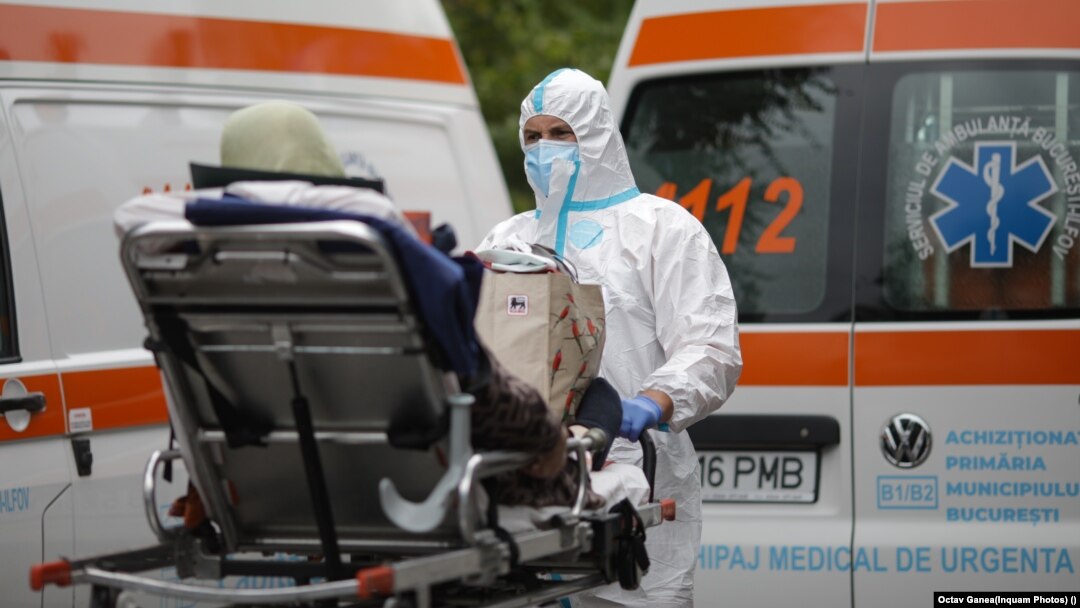 Ambulances wait in front of the University Hospital in Bucharest to hospitalize patients.
